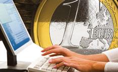 Büroarbeitsplatz vor einer 1 Euro Münze