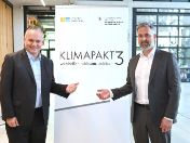 Wirtschaftsreferent C. Scharpf und Professor A. Levermann vor Klimapakt 3-Logo