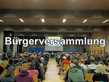 Bürgerversammlung im Jahr 2024: Bürgerinnen und Bürger haben sich in einer Turnhalle versammelt, in welcher soeben ein Vortrag abgehalten wird.